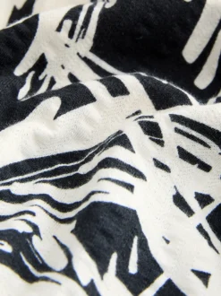 Noir/blanc imprimé palmiers - Robe mi-longue boutonnée en jersey